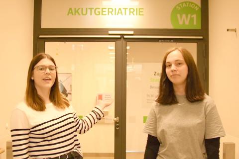 Startbild des neuen Youtube-Clips "Ausbildung im SJS" – zwei Pflegeschülerinnen laden zum Rundgang auf Station ein.