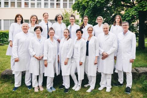 Gruppenfoto Ärztinnen und Ärzte der Klinik für Gynäkologie und Geburtshilfe am Krankenhaus St. Joseph-Stift, Aufnahme im Patientengarten im Mai 2025.