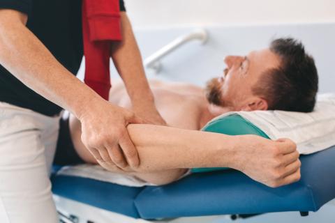 Sportmedizinische Diagnostik, Ganzkörperuntersuchung. Ärztin, Patient.