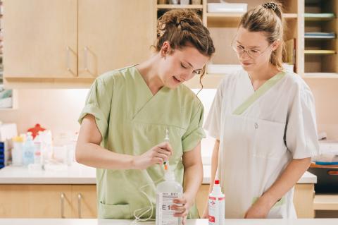 Pflegeausbildung in der Berufsschule: Praktische Anleitung beim Herstellen einer Infusionslösung auf der Station im Krankenhaus.
